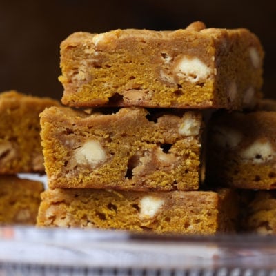 Image of 3 stacked pumpkin blondies with white chocolate chips