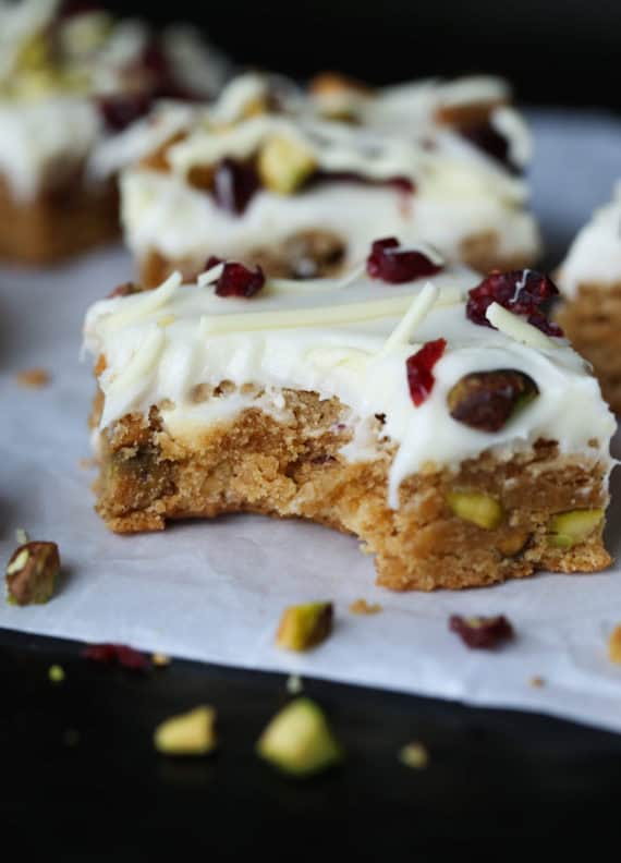 Cranberry Pistachio Bliss Bars are chewy blondies topped with cream cheese frosting