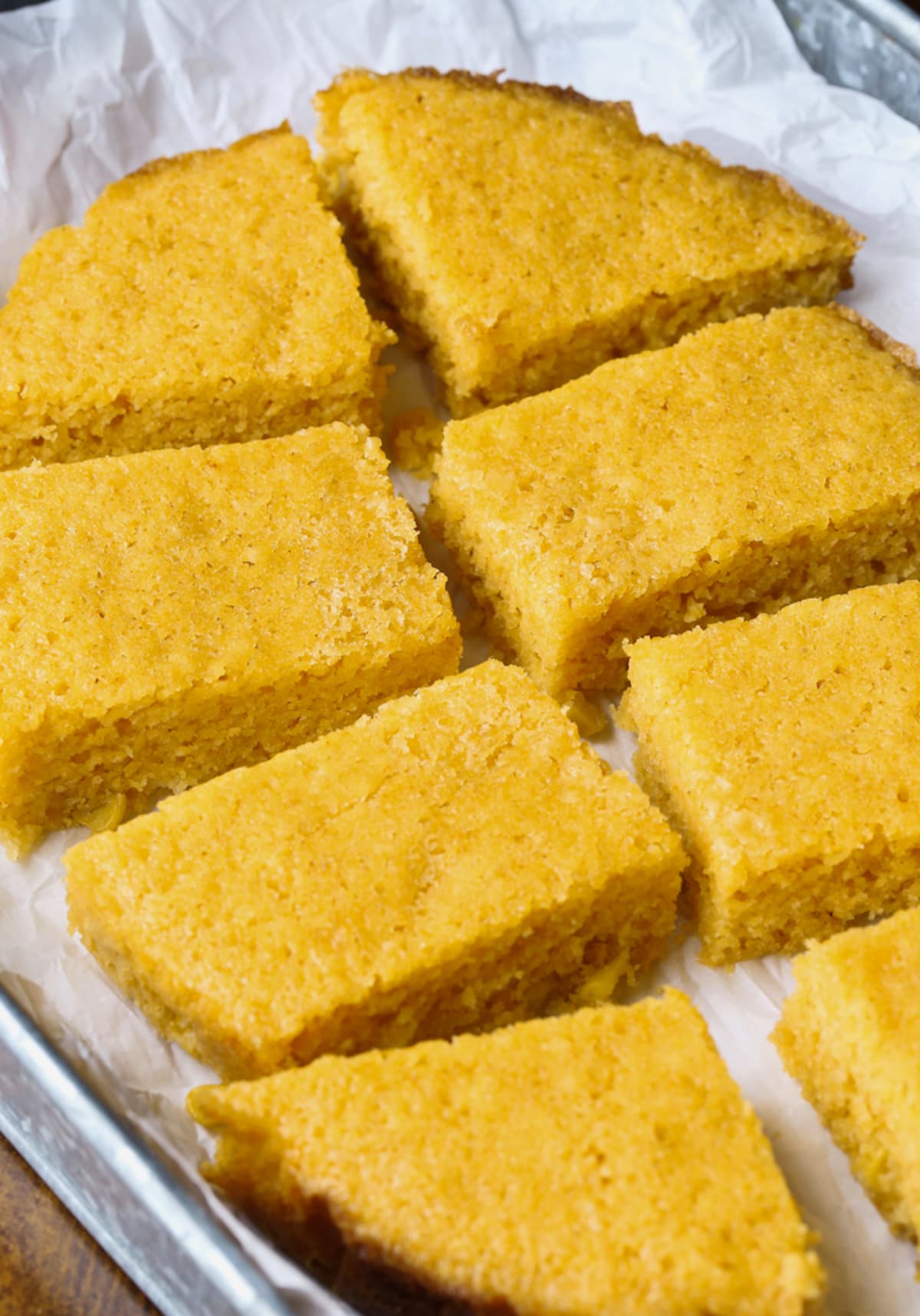 Sliced Crock Pot Cornbread on a piece of parchment paper