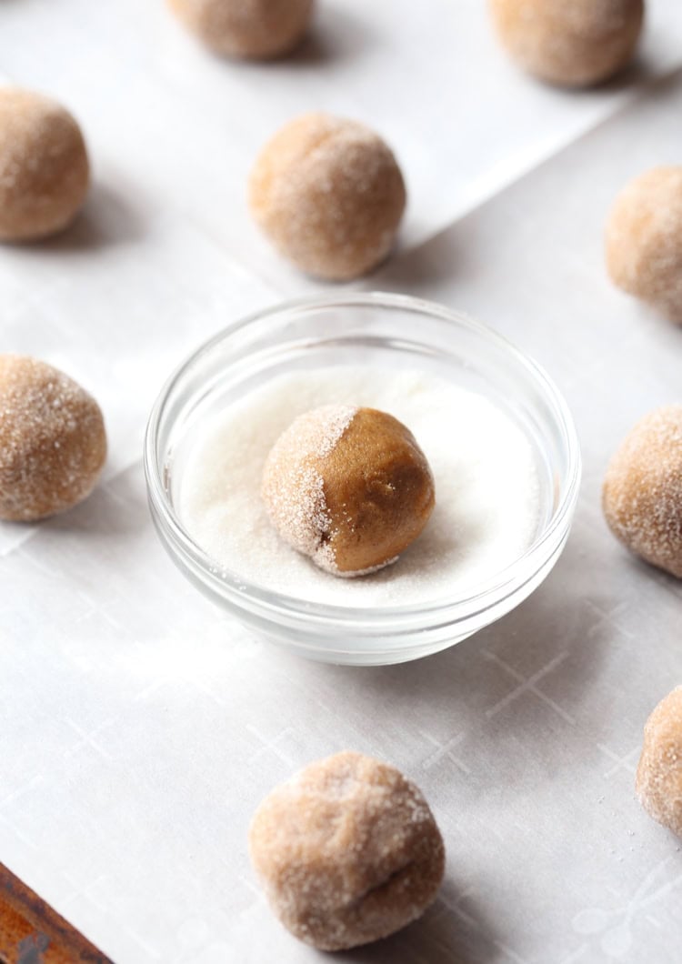 Balls of gingersnap dough being rolled in sugar