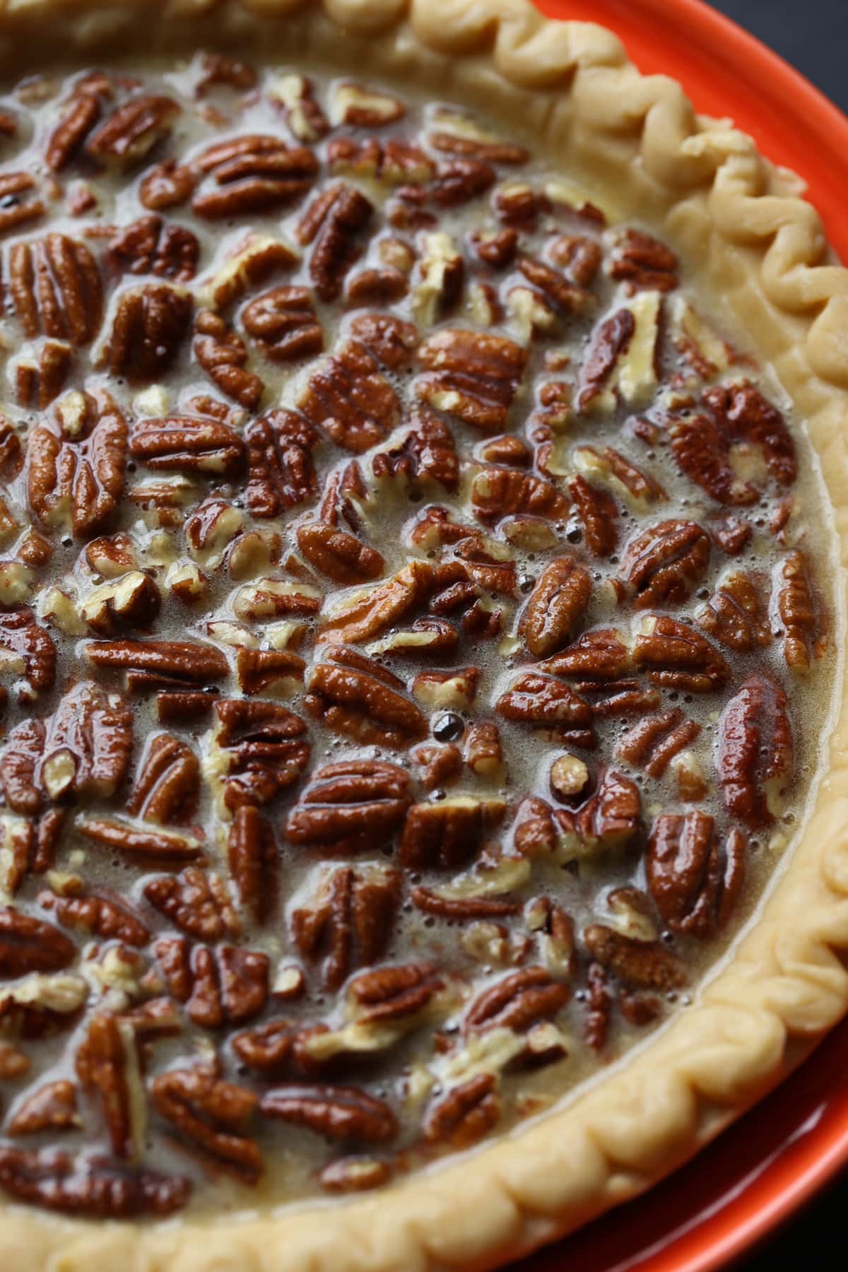Pecan Pie filling in an unbaked pie shell before going into the oven