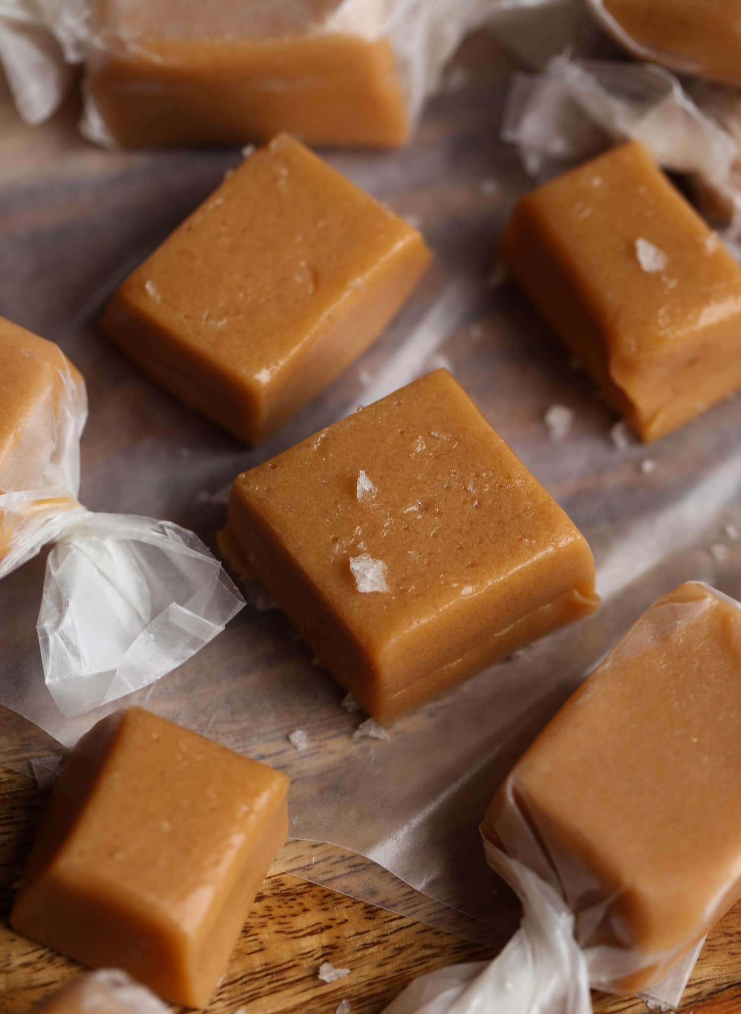 Homemade caramel candies on parchment paper sprinkled with sea salt
