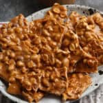 Homemade peanut brittle served on a plate.