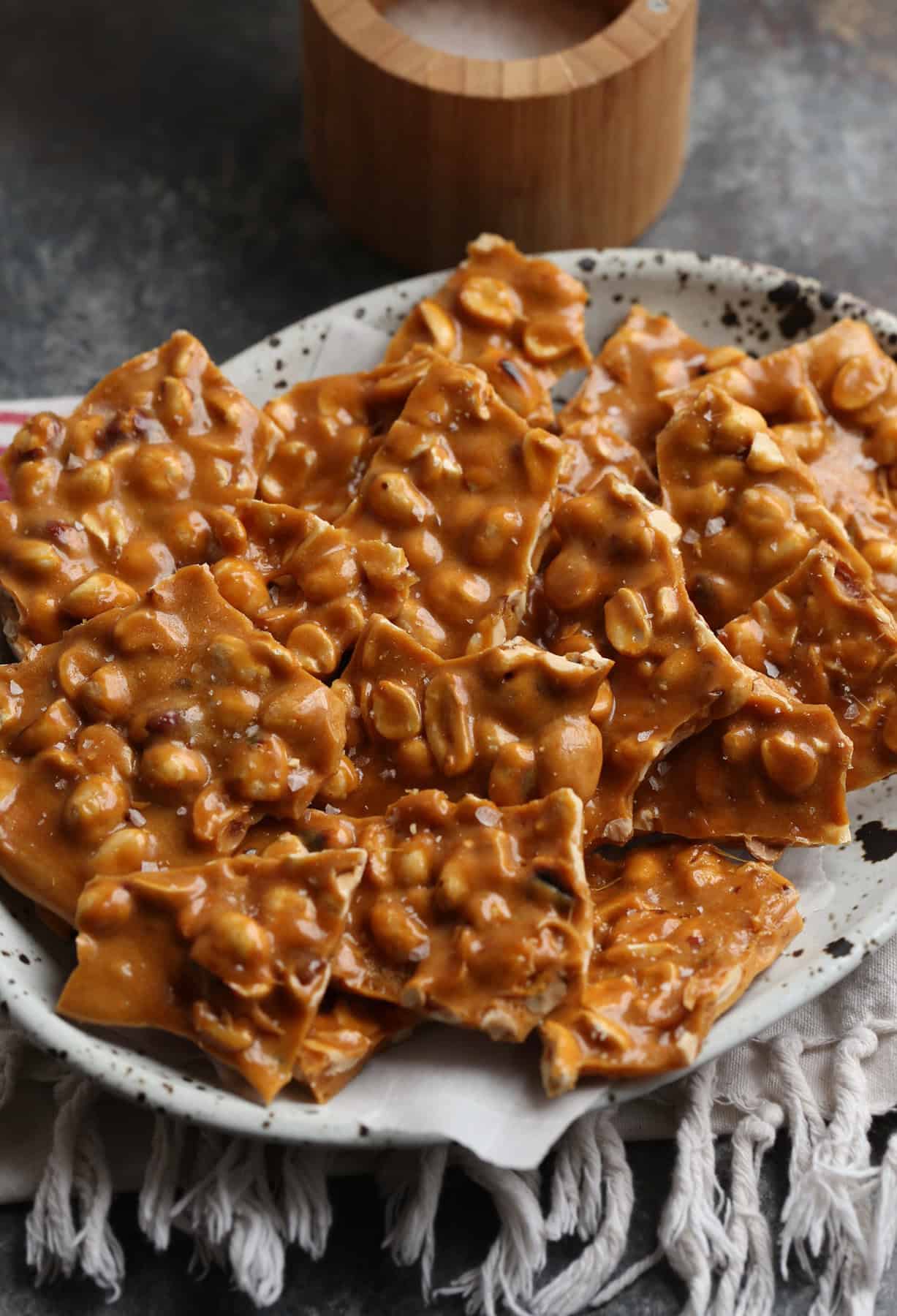 Homemade peanut brittle served on a plate.
