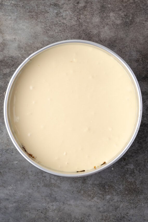 Cheesecake batter in a round springform pan.