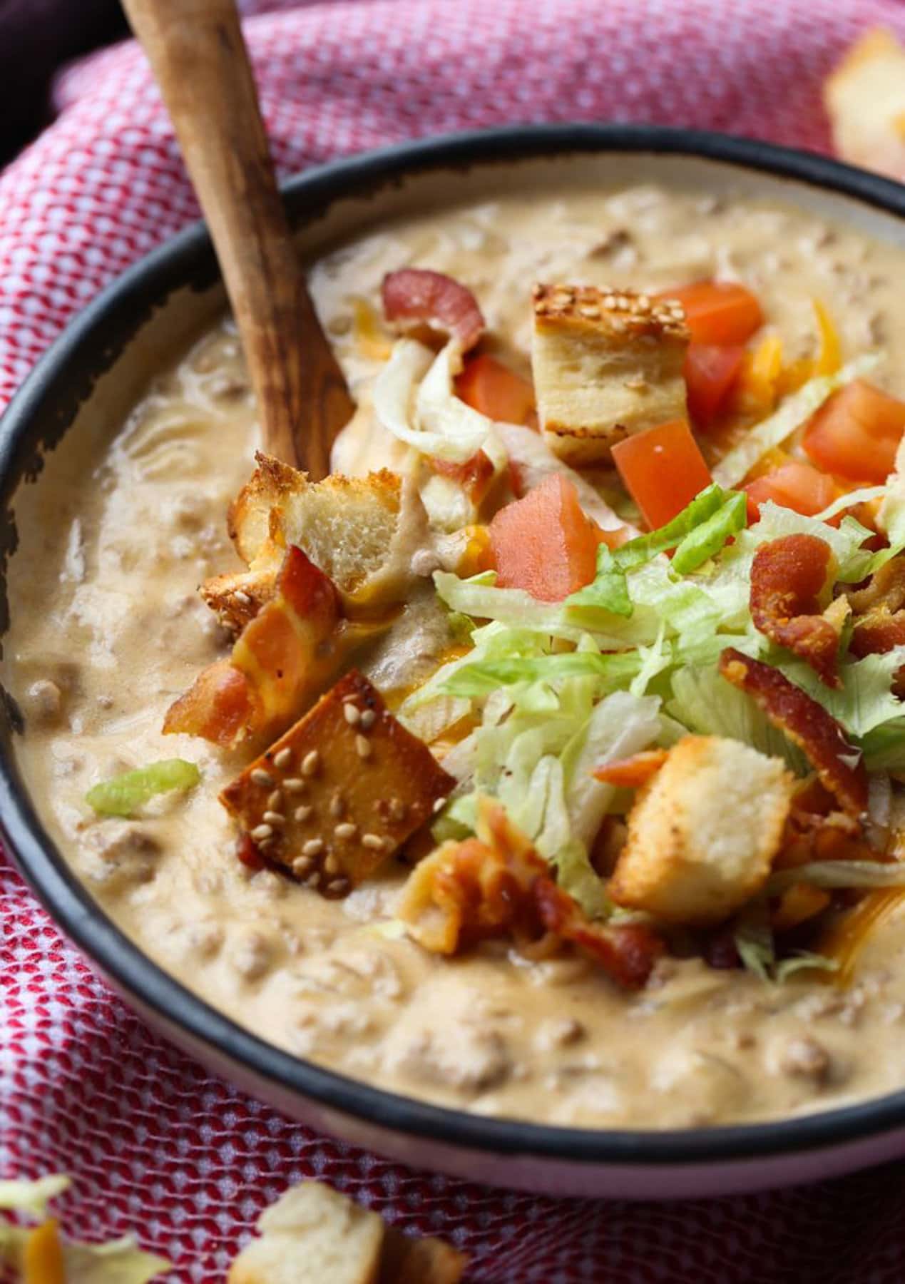 Cheeseburger soup served with a spoon