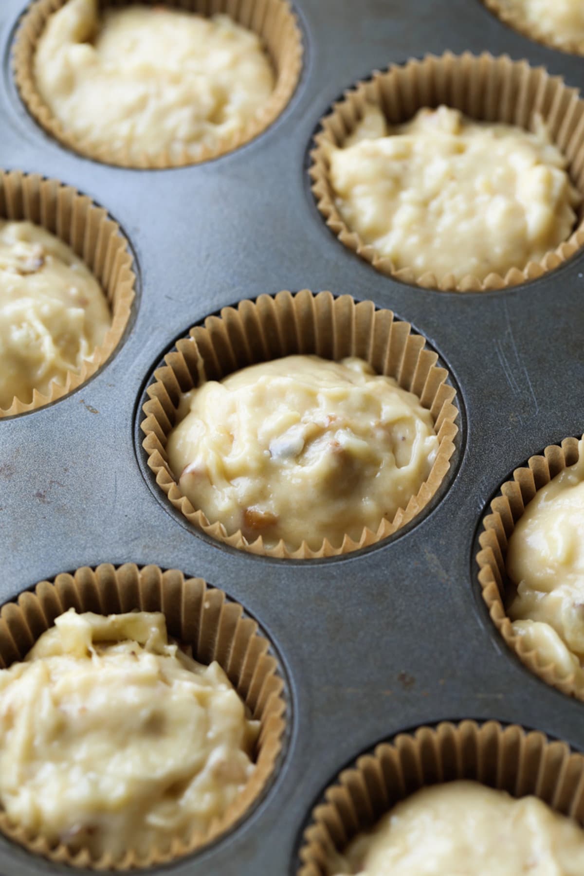 banana muffin batter in a liner in a muffin pan