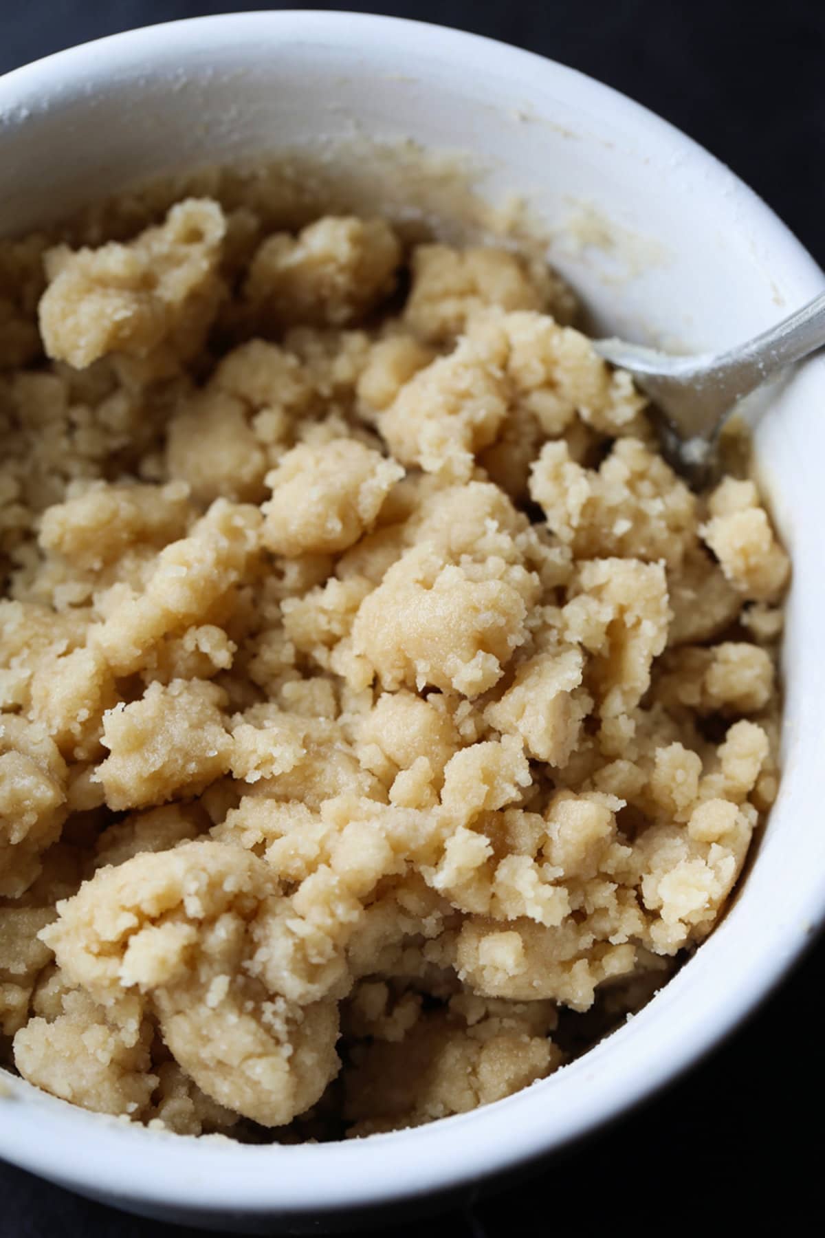 a white bowl full of crumb topping