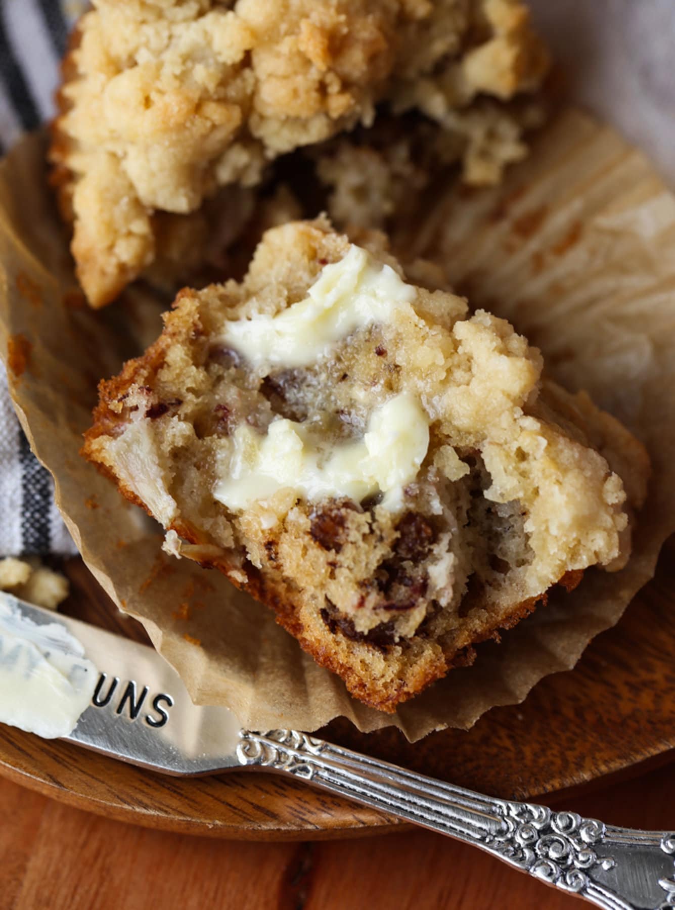 Banana muffin split in half on a buttered liner