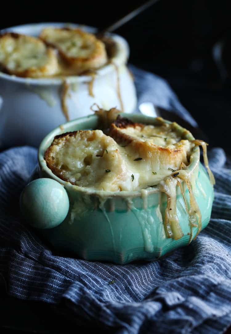 French onion soup in a ramekin topped with cheesy bread
