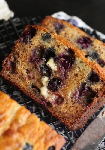 Blueberry banana bread sliced with butter on top