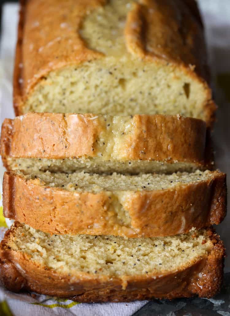 Front view of a lemon poppy seed pound cake cut into slices.