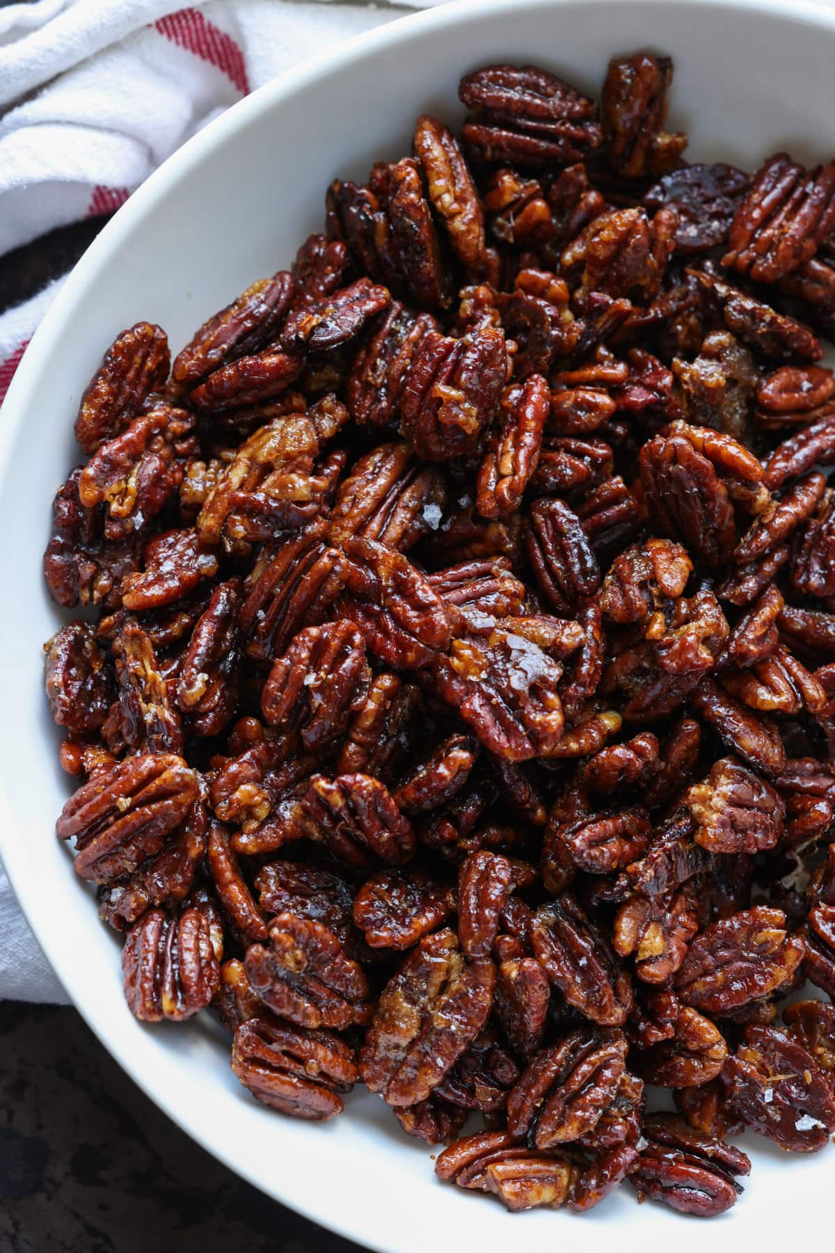 Overhead view of a bowl full of candied pecans.