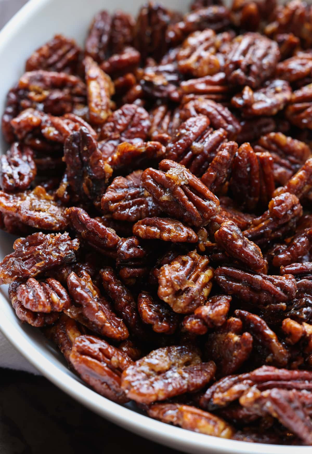 Close up of candied pecans in a bowl.