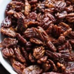 Overhead view of a half of a bowl filled with candied pecans.