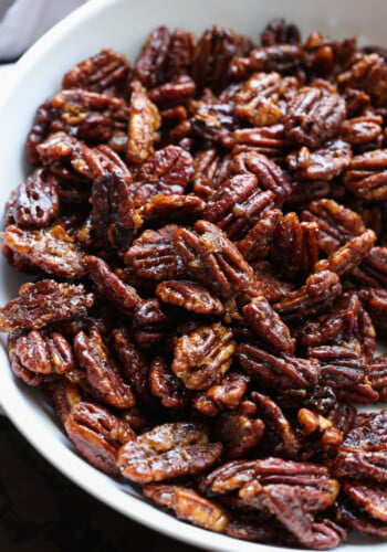 Overhead view of a half of a bowl filled with candied pecans.