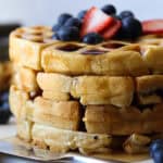 This Buttermilk waffles recipe is topped with berries and coated in maple syrup