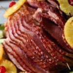 Pineapple-baked ham displayed with pineapples and cherries