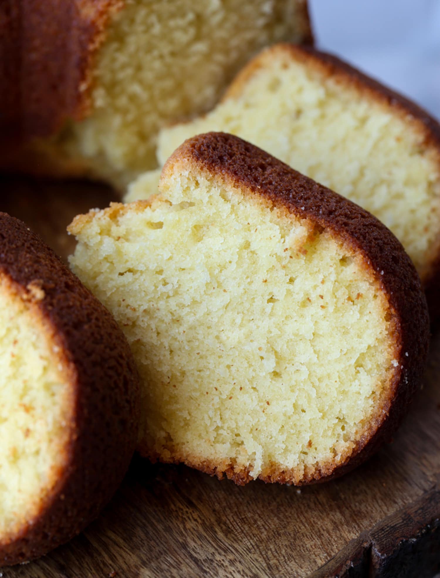 Slices of pound cake on a wooden cutting board