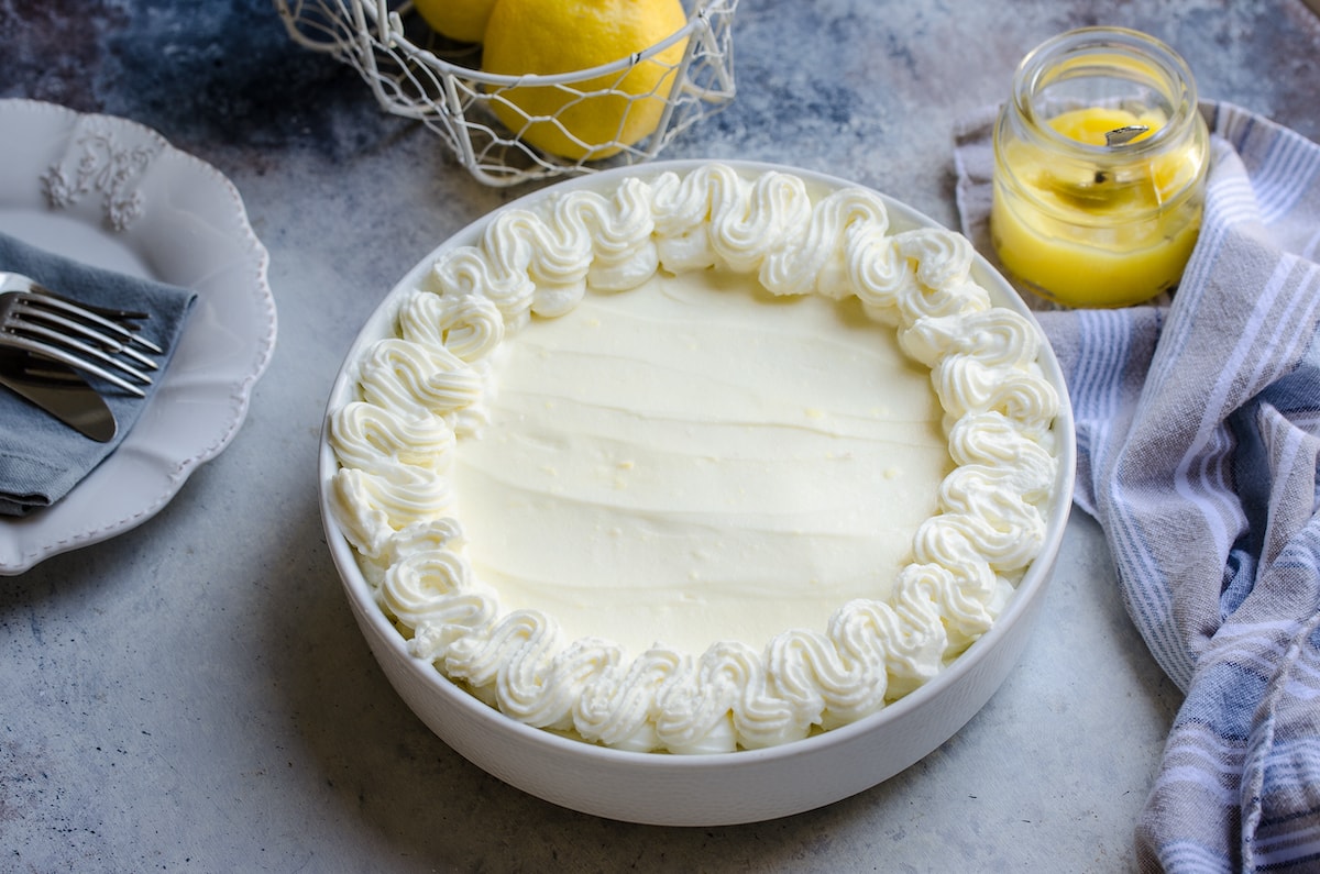 A lemon pie with piped whipped cream.