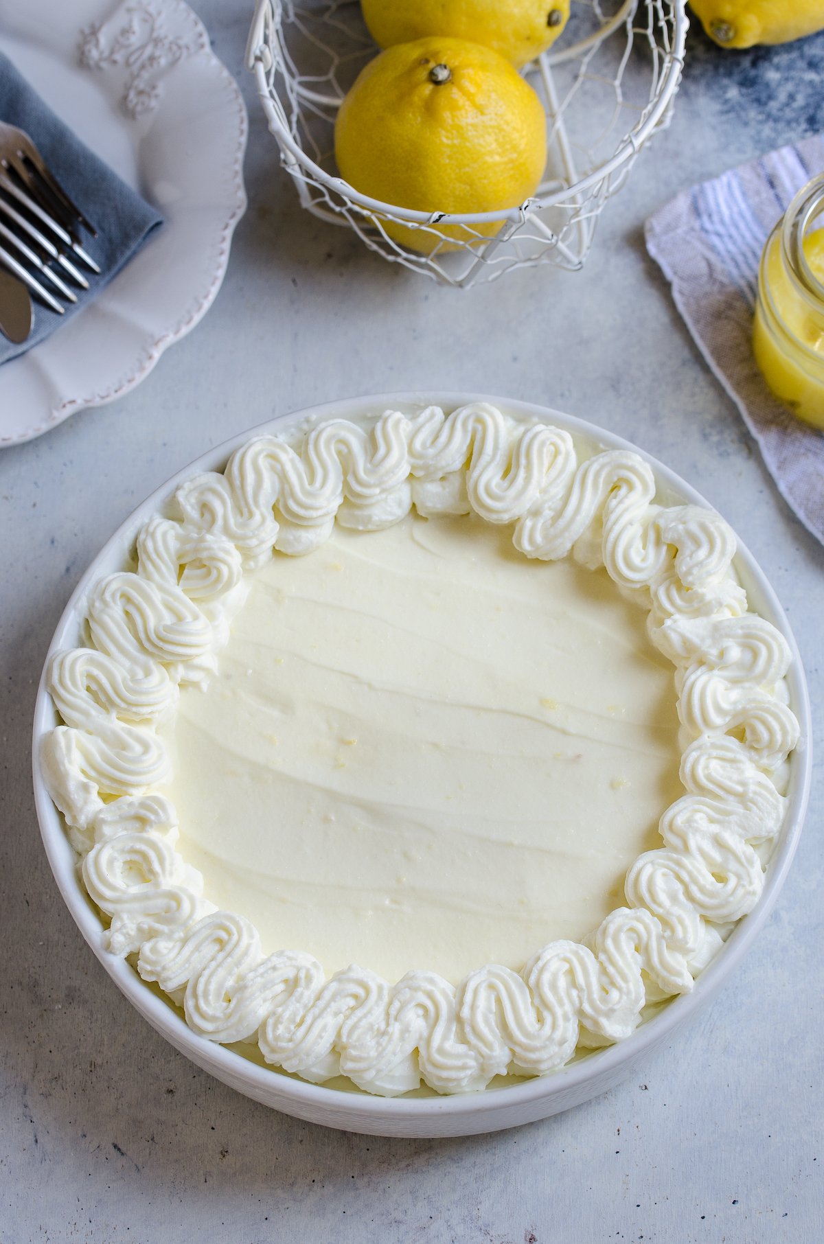 A pan of lemon pie with whipped cream.
