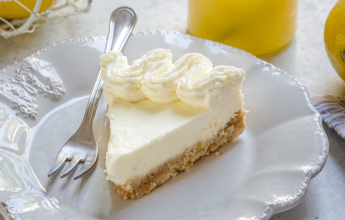 A slice of lemon pie with whipped cream.