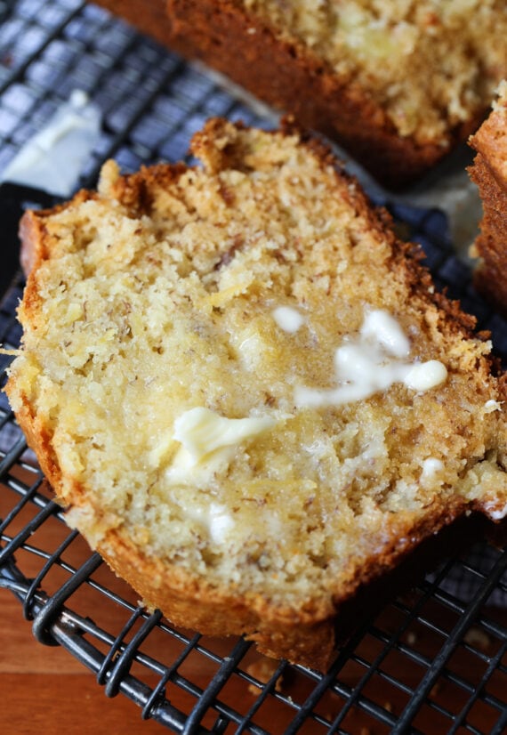 Pineapple Banana Bread sliced with butter