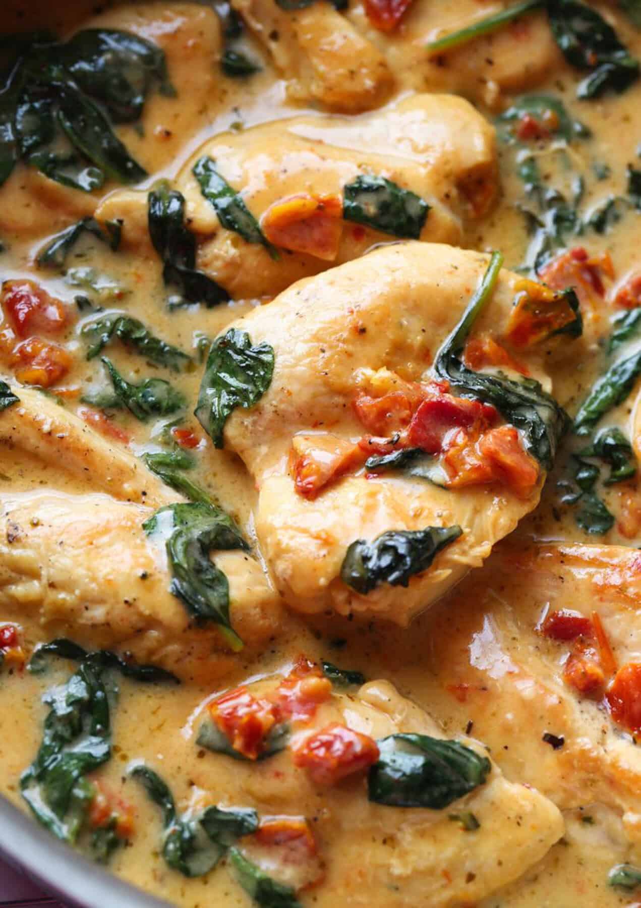 Easy Tuscan Chicken Recipe is made in a cream sauce with spinach and sun dried tomatoes