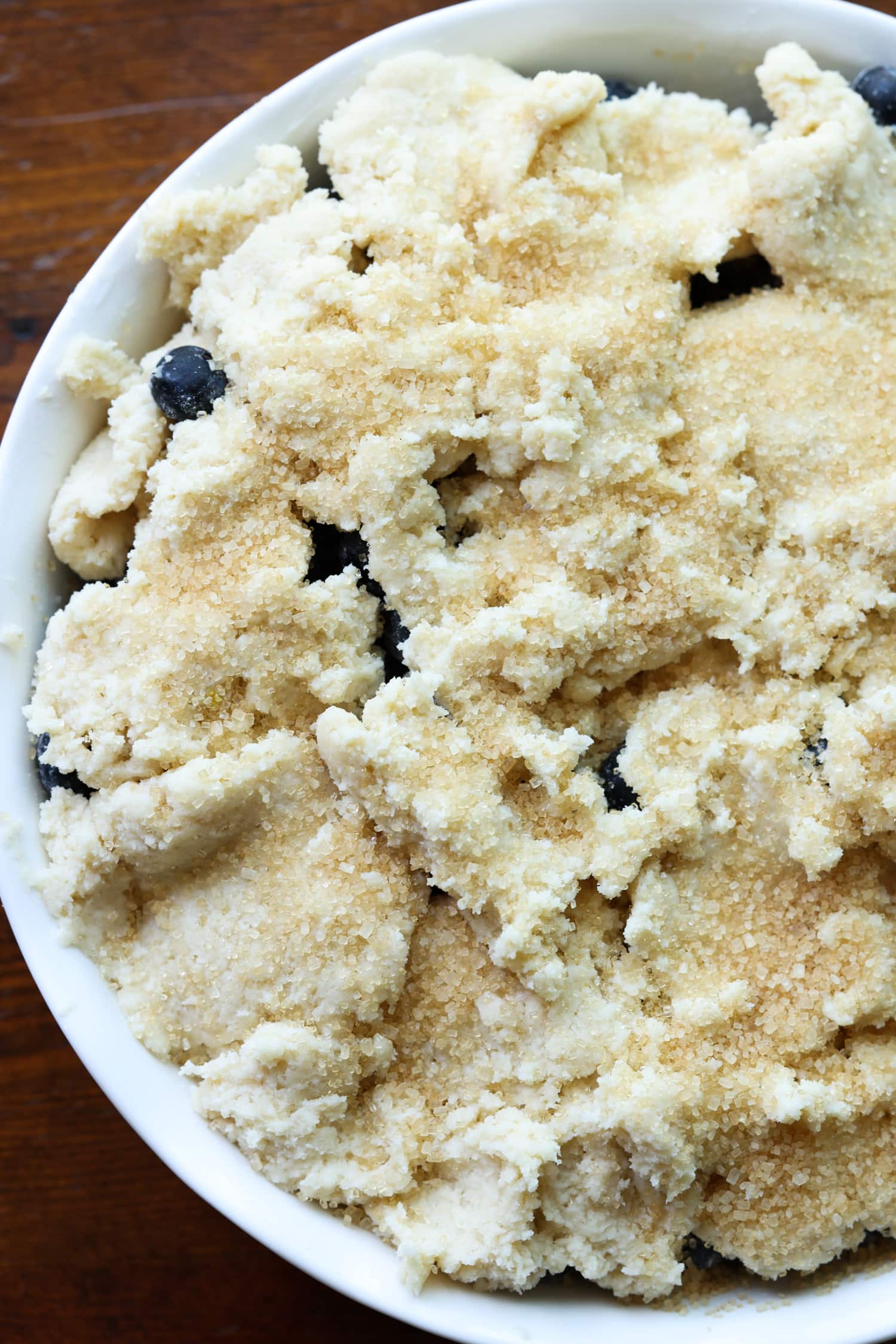 blueberries in a baking dish topped with sweet biscuit dough