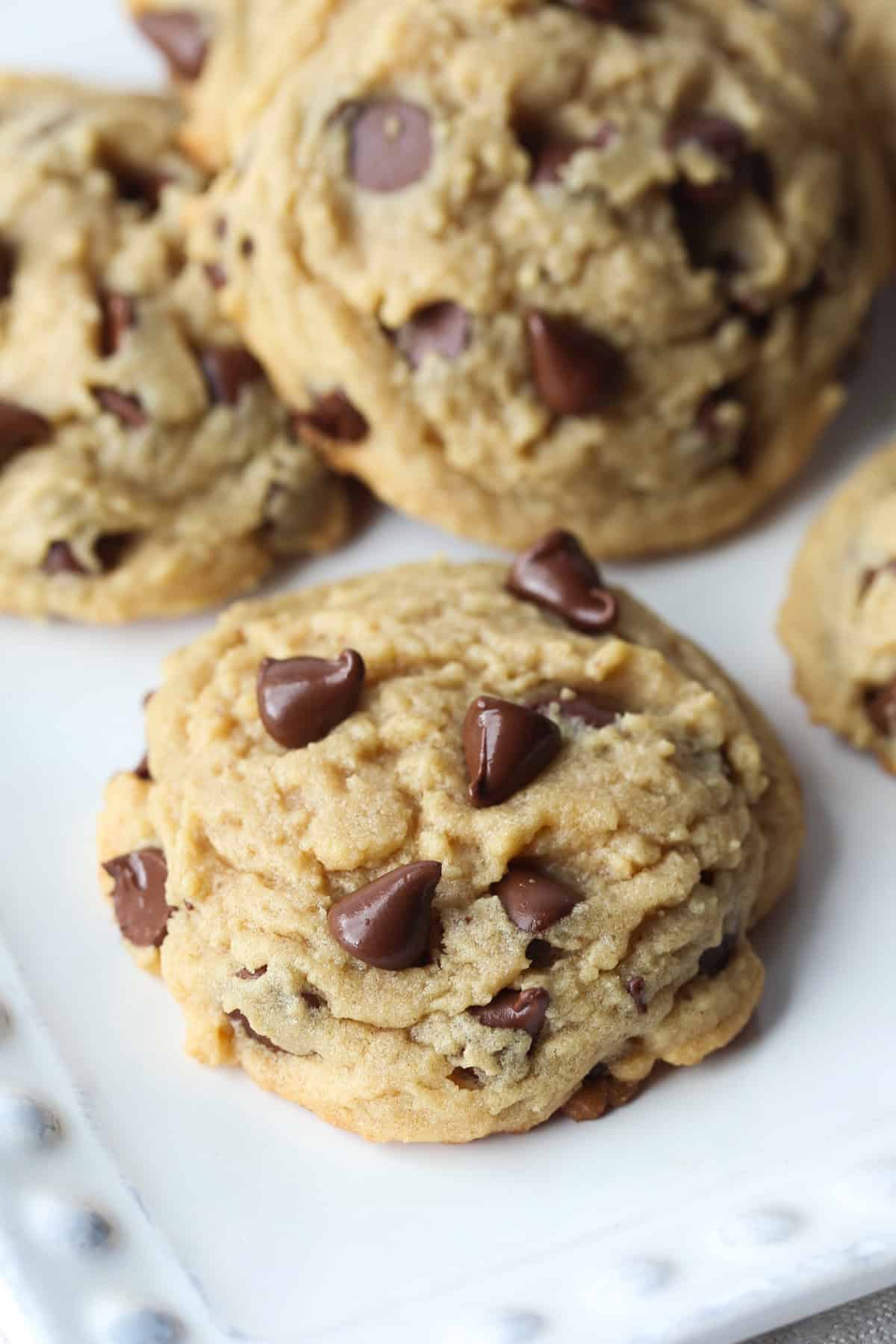 Peanut butter cookies with chocolate chips on a white plate.