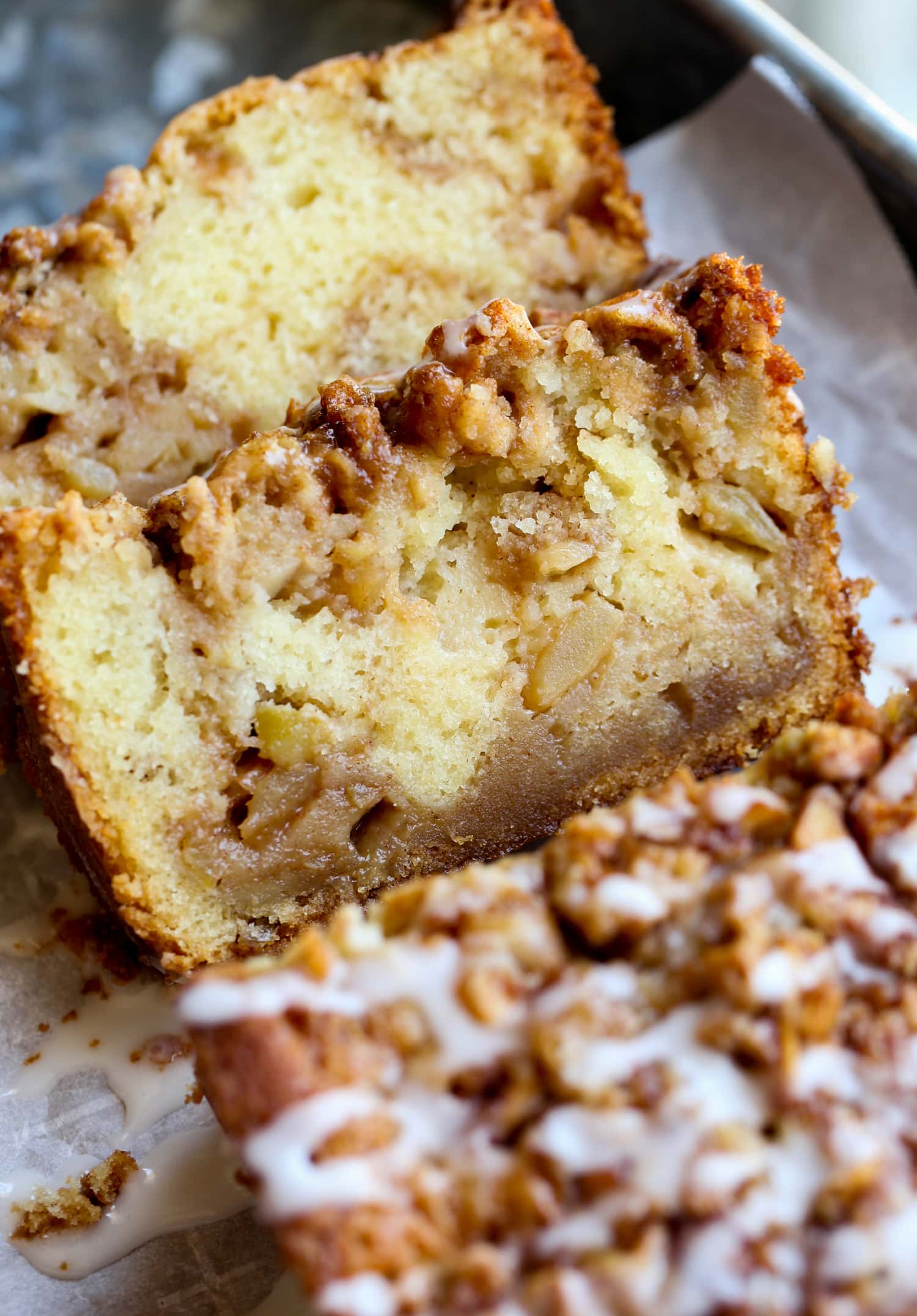 2 slices of apple bread showing the cinnamon sugar and apple mixture throughout.