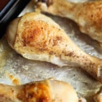 Oven baked chicken legs on a baking sheet