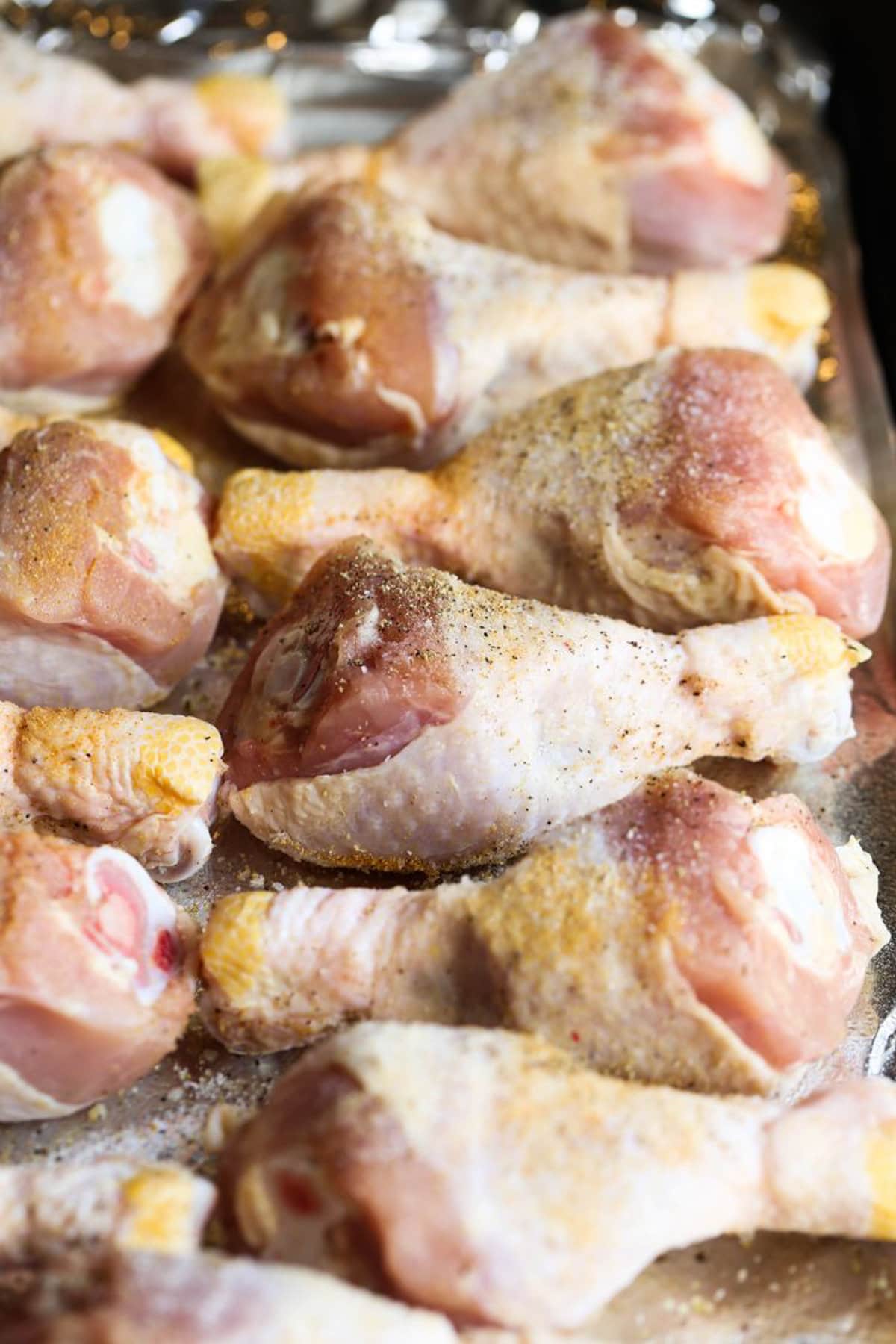Seasoned chicken legs ready to be baked