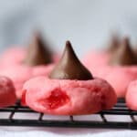 Cherry cookies with a Hershey's Kiss pressed on top on a wire rack