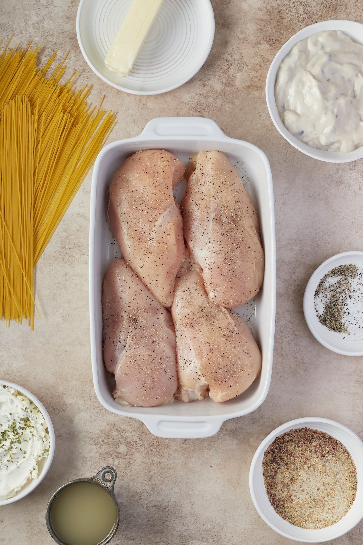 Seasoned chicken breasts in a baking dish.