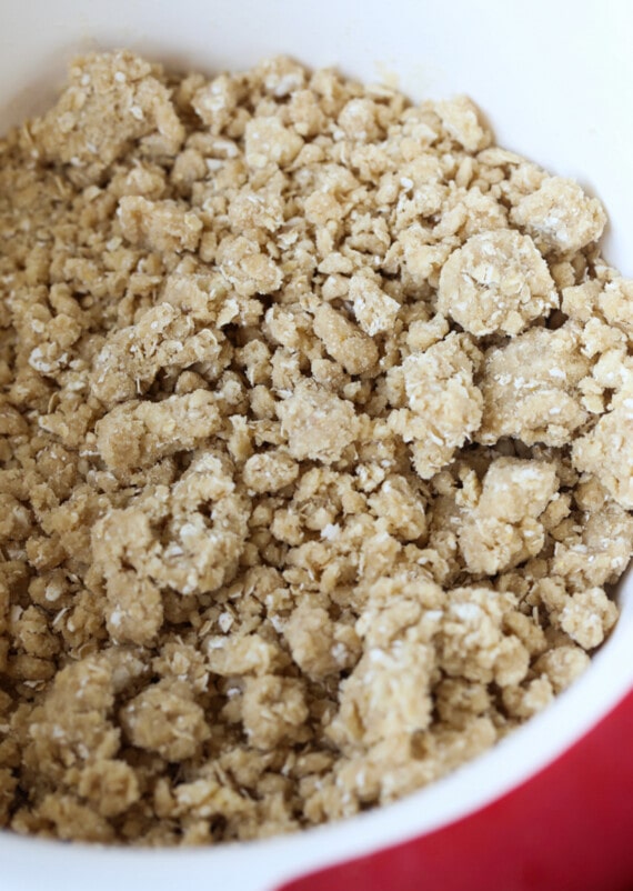 Prepping crisp topping made from oats, flour, butter, and sugar in a bowl