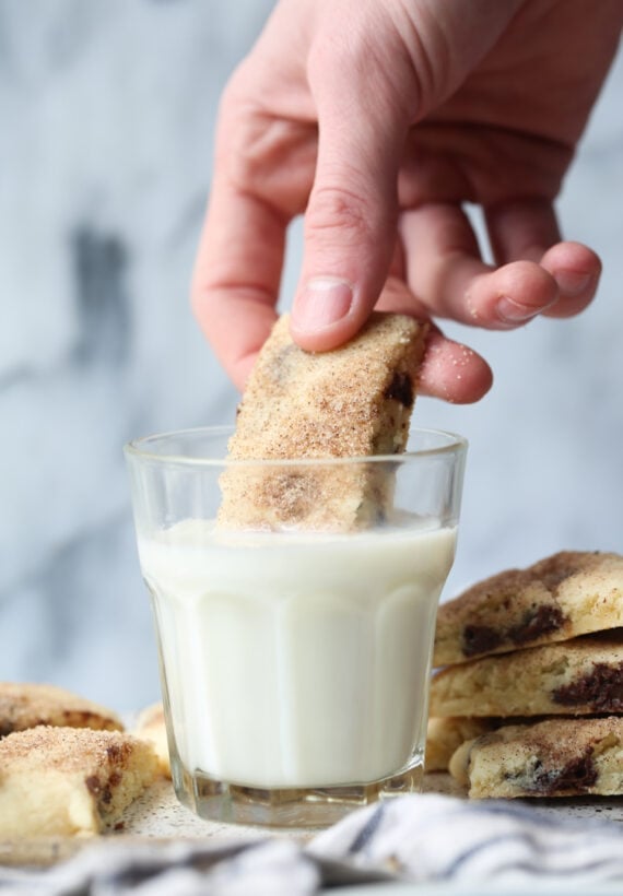 Dunking chocolate chip cookie in milk