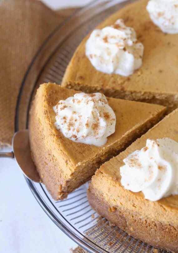 Sliced Pumpkin Cheesecake with whipped cream