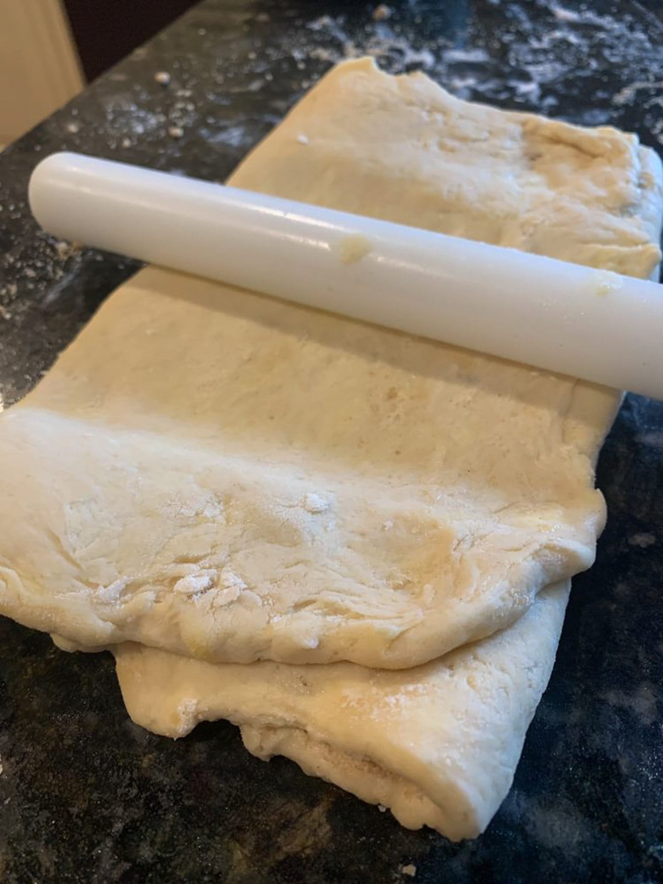 rolling the folded dough into half an inch