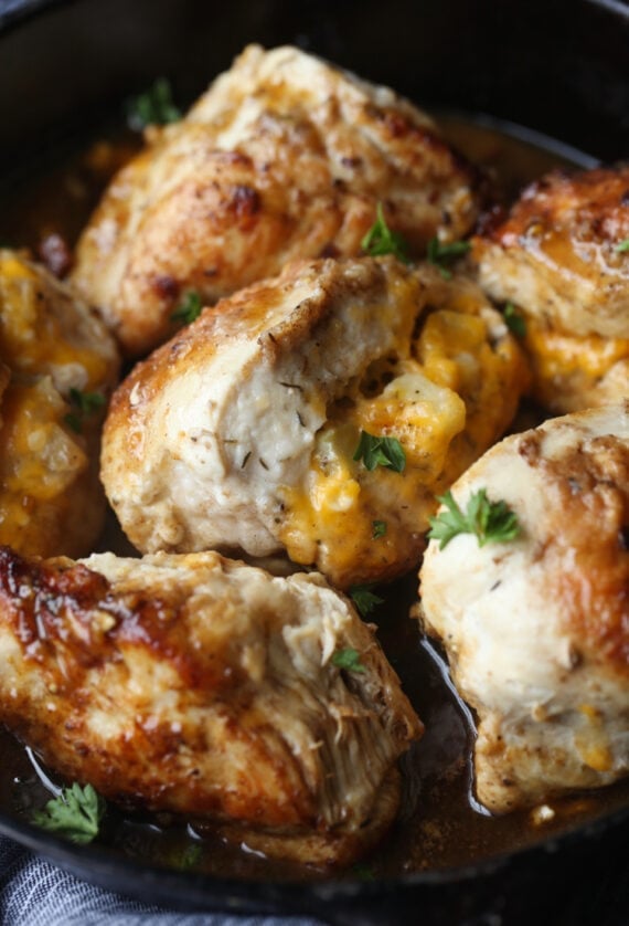 Apple and cheese stuffed in a chicken breast cooked in a skillet