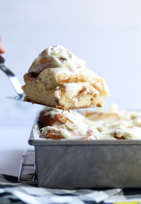 Serving a cinnamon bun on a spatula from the 9x13 pan