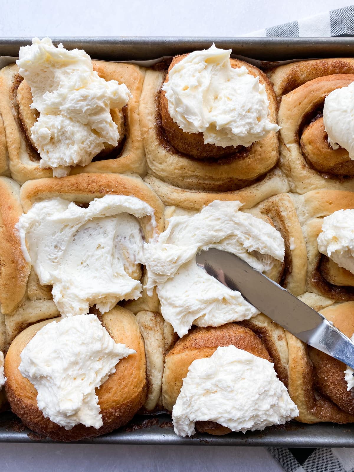 Baked Cinnamon Rolls topped with frosting