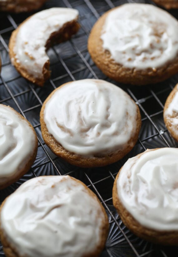 Pumpkin Molasses Cookies with vanilla icing on a cooling rack