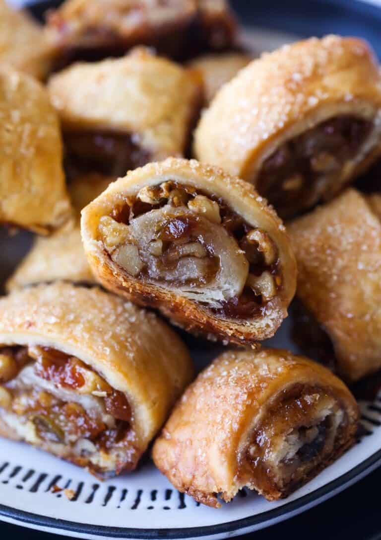 Assorted Rugelach cookies filled with nuts and fruit on a plate.