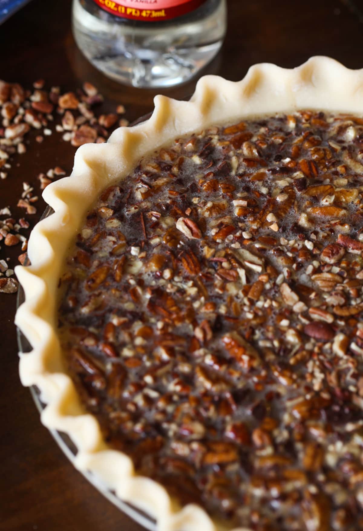 An unbaked chocolate pecan pie in a pie shell before putting it in the oven.