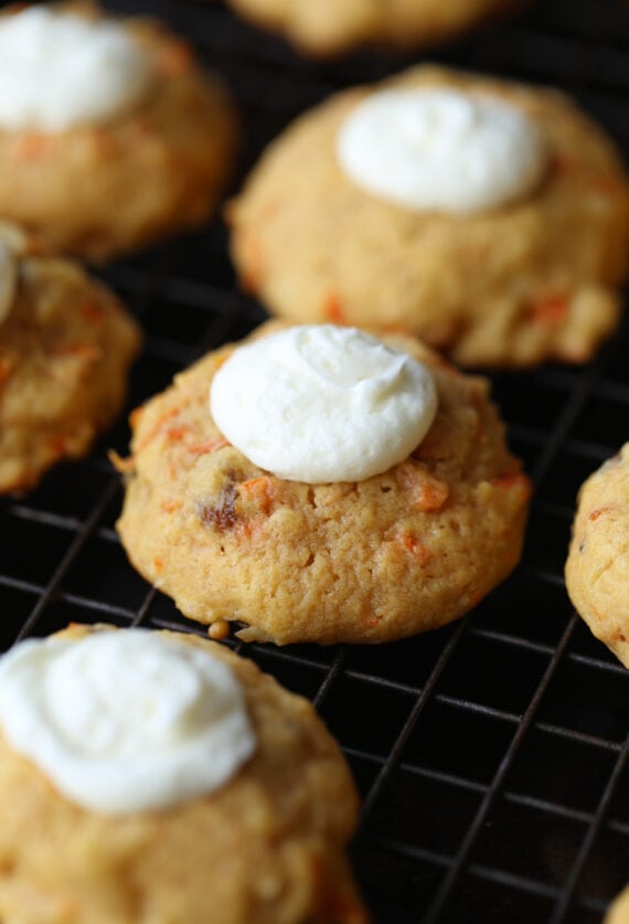 Carrot Cake Thumbprint Cookies on a plate with cream cheese frosting