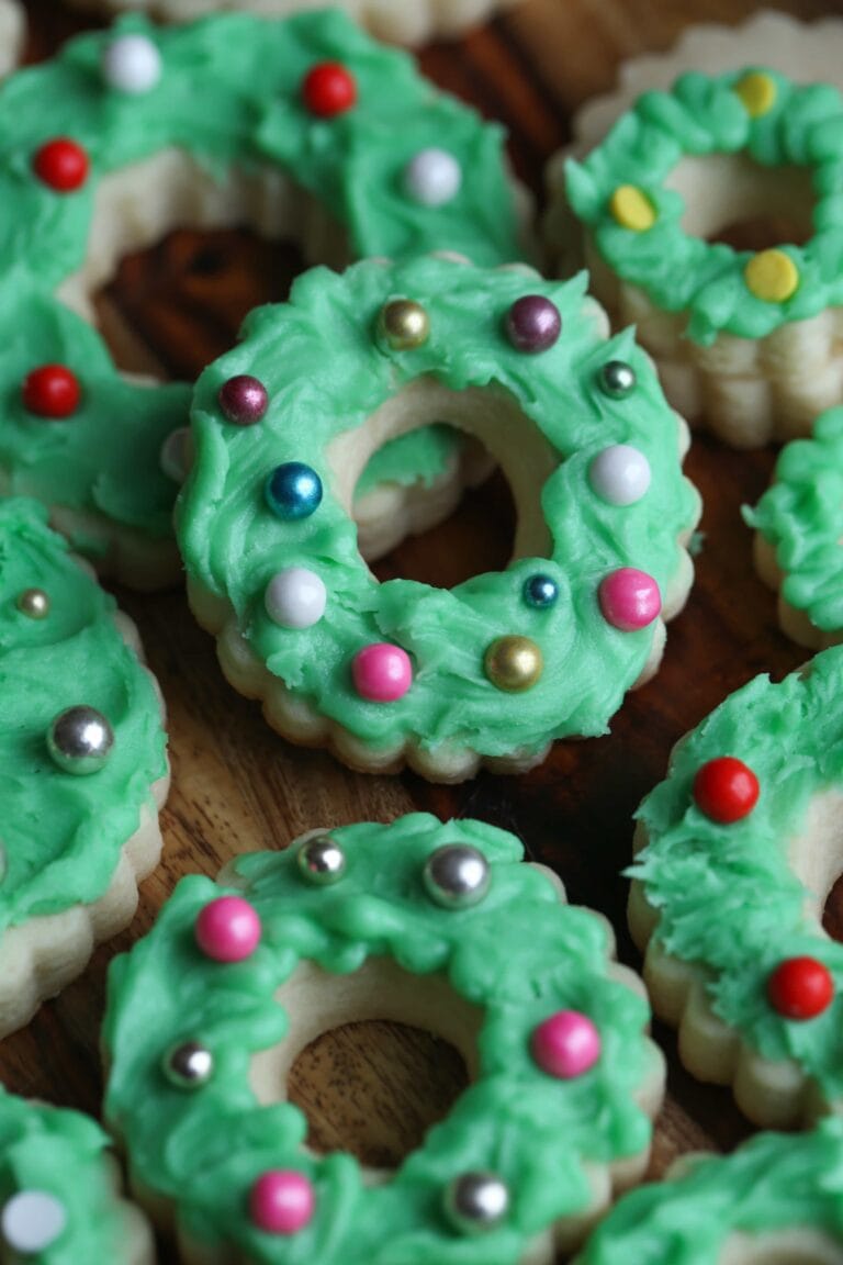 Assorted Christmas Wreath Cookies on a wooden countertop.