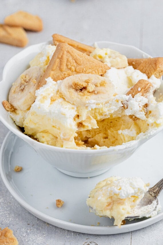 Banana Pudding in a bowl with a bite and spoon taken out