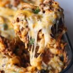 Serving Chili Mac Casserole with cheese pull