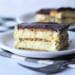 Eclair Cake on a plate with layers of vanilla pudding and graham crackers